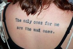 the back of a woman's neck with a tattoo saying, the only ones for me are the mad ones