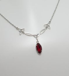 This is a new handmade necklace. It is made with antiqued silver plated Celtic knots, accented with a high quality DARK RUBY RED/GARNET glass jewel that sparkles like crystal. Decorated portion is 2 1/2" wide and 1 1/4" tall in the center. Necklace is adjustable 15-18" with a lobster clasp and chain extender. If you would like a different length, please send us a message.Matching earrings and headpiece are listed in our store in a variety of stone colors. If you don't see items with a color you Luxury Red Necklaces For Rituals, Red Gem Jewelry, Ruby Red Necklace, Red Stone Necklace, Celtic Goddess, Formal Jewelry, Red Accessories, Celtic Knots, Red Necklace