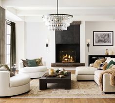 a living room filled with furniture and a fire place in the middle of the room