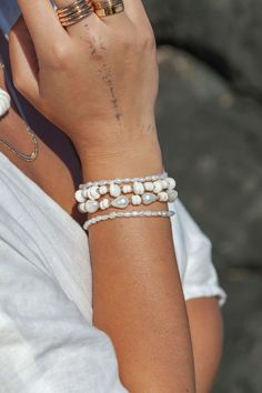 "This beaded bracelet features a collection of tiny white freshwater pearls to capture the enticement of Hawaii's white sand beaches. Wear this gold pearl bracelet alone or stracked for a classically elegant allure. ✦ DETAILS ✦ ✧ Name: Maile (MIE-leh) - vine. ✧ Adjustable Length from: 6\"-7.5\" Inches. ✧ White 3-4mm Freshwater Pearls. ✧ 14kt Gold Filled Components, Extender, and Clasp. ✧ All Ke Aloha Jewelry pieces come packaged thoughtfully, beautifully, and ready for gift giving. ✦ MORE GOLD B Bohemian Pearl Bracelets With Pearl Charm, Handmade Dainty Pearl White Bracelets, Adjustable Stackable Pearl Bracelet, Pearl White Beaded Bracelet With Pearl Drop, White Pearl Stretch Bracelet With Pearl Charm, Adjustable Bangle Bracelet With Pearl Drop, Adjustable Hand-strung Pearl White Pearl Bracelet, Everyday White Pearl Drop Bracelets, Adjustable Hand-strung White Pearl Bracelet