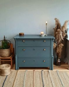 a blue dresser sitting on top of a wooden floor