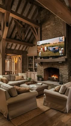 a living room filled with furniture and a flat screen tv mounted on the wall above a fireplace