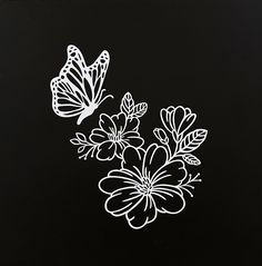 two butterflies flying over flowers on a black background