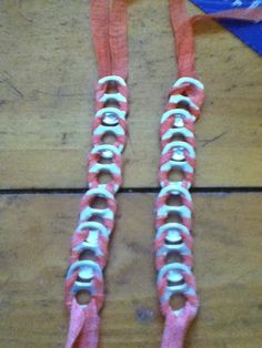 two pairs of pink and white laces on wooden floor