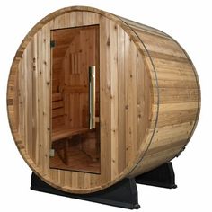 a wooden barrel sauna is shown with the door open