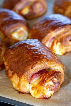 several pastries sitting on top of a piece of wax paper