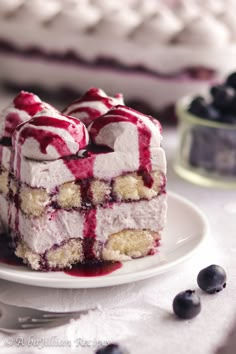 a piece of cake on a plate with blueberries