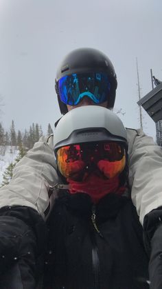 a man wearing ski goggles and a helmet in the snow