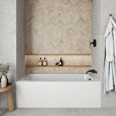 a white bath tub sitting next to a wooden shelf