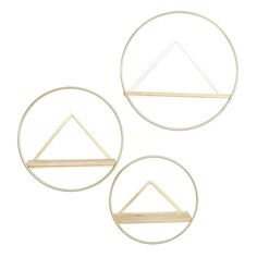 three gold metal shelves with geometric shapes on them