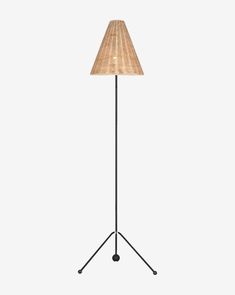 a floor lamp with a wooden shade on it