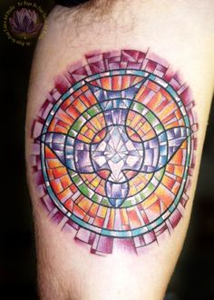 a colorful tattoo design on the left arm and leg, with an abstract cross in the center