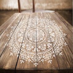 a wooden table with white designs on it