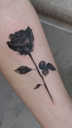 a black rose tattoo on the arm