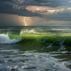 a large wave in the ocean with a lightning bolt coming out of it's center