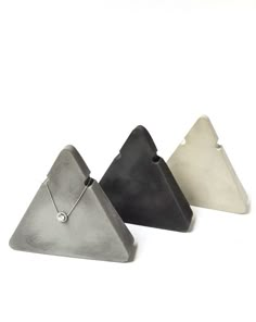 three triangle shaped pendants on white background