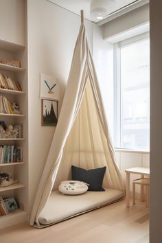 a room with a bed, bookshelf and window