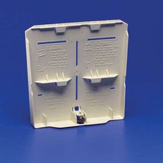 a white plastic box with two shelves on the front and one in the back, against a blue background