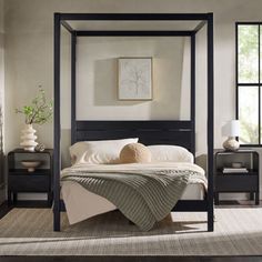 a bedroom with a four poster bed and two nightstands