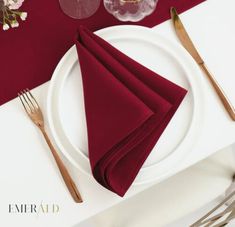 the place setting is set with red napkins and silverware