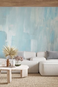 a living room with blue and white paint on the walls