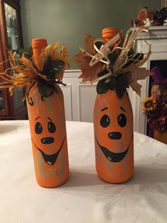 two painted pumpkins sitting on top of a table