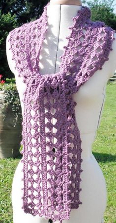 a purple crocheted scarf on top of a mannequin