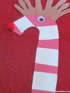 a paper bag with a hand and eye on it that is made to look like a candy cane