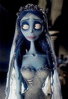 the corpse bride doll is dressed in white and blue with long hair, wearing a veil