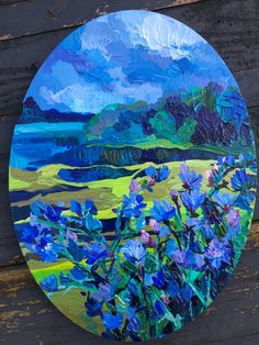 a painting of blue flowers on a wooden surface