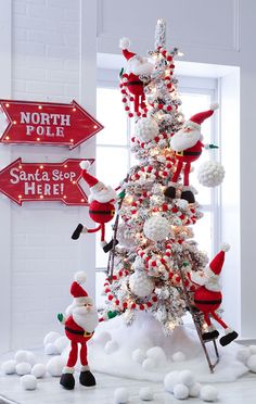 a decorated christmas tree with santas on it