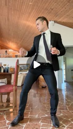 a man in a suit and tie is dancing