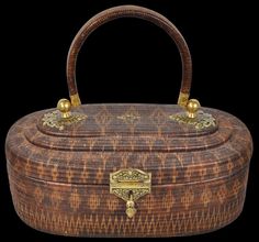 an old wooden box with gold handles on a black background