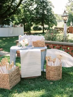 a table with umbrellas and baskets in the grass