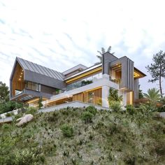 a modern house on top of a hill