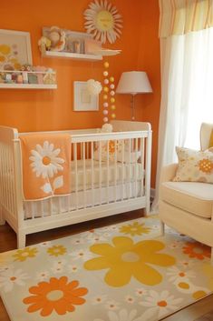 a baby's room with an orange wall and white crib