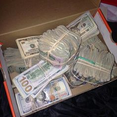 a box filled with lots of money sitting on top of a table