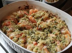 a casserole dish with shrimp and herbs in it