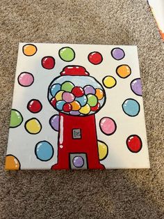 a painting of a gumball machine on the ground