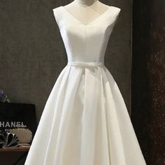 This Beautiful New White Dress With A V-Neck, Small Bow At Waist And A Button And Lace Up Back. This Dress Is Perfect For Any Special Occasion. Fully Lined. Size 4 With Built In Bra Cup. Tea-Length. Never Worn/Tags Are Still On. Has A Satin Sheen To It. White V-neck Midi Dress For Wedding, White A-line V-neck Wedding Dress, Classic V-neck Wedding Dress, Dress Tea Length, Masquerade Theme, Beautiful White Dresses, Fuchsia Dress, Lace Up Dress, Graduation Dresses