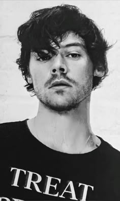 a black and white photo of a man wearing a t - shirt with the words treat bread on it