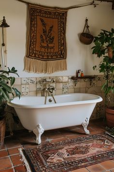 a bath tub sitting on top of a tiled floor next to a potted plant