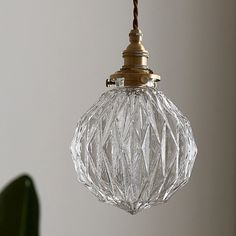 a glass ball hanging from a ceiling light