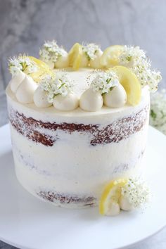 a white cake with lemon slices and flowers on top