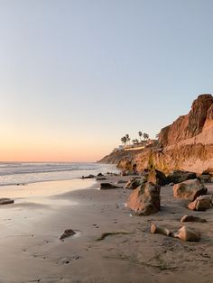 the beach is covered in rocks and sand