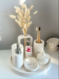 the bathroom accessories are arranged neatly on the counter