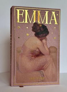 an old book with the title'emma'written in gold lettering on it