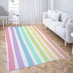 a living room with a white couch and rainbow rug