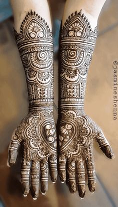 two hands with henna designs on them