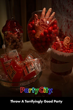 there are candy and candies on the table with words party city throw a terrifyingly good party